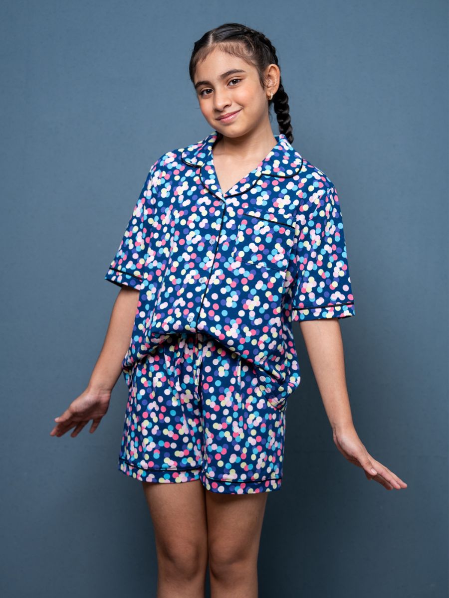 Girl wearing a blue floral pajama set against a gray background