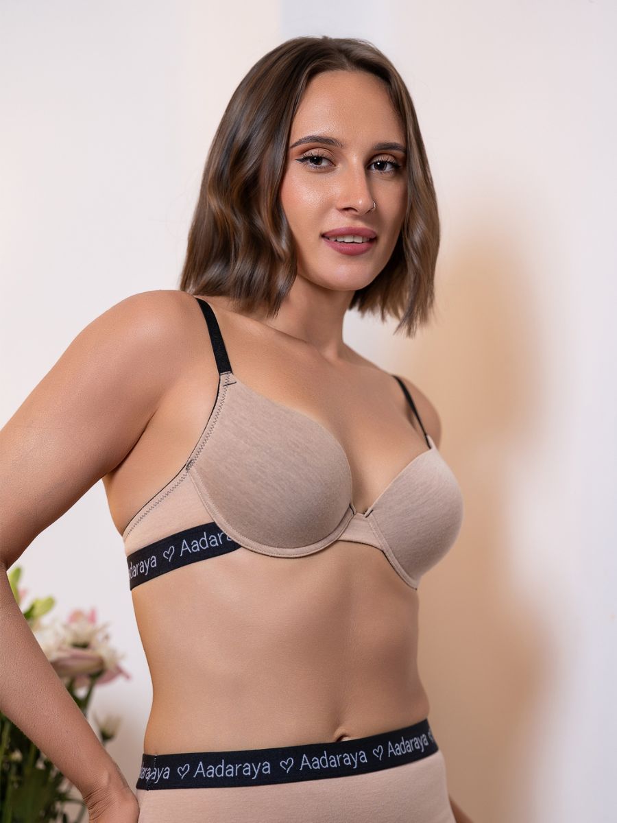 Woman wearing a beige bra with ‘Aadaraya’ branding on a neutral background