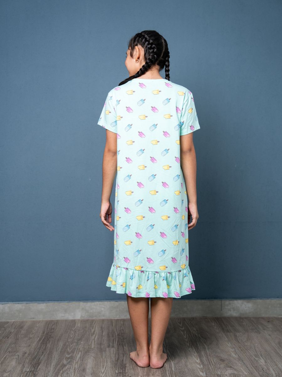 Girl wearing a light blue dress with colorful popsicle pattern