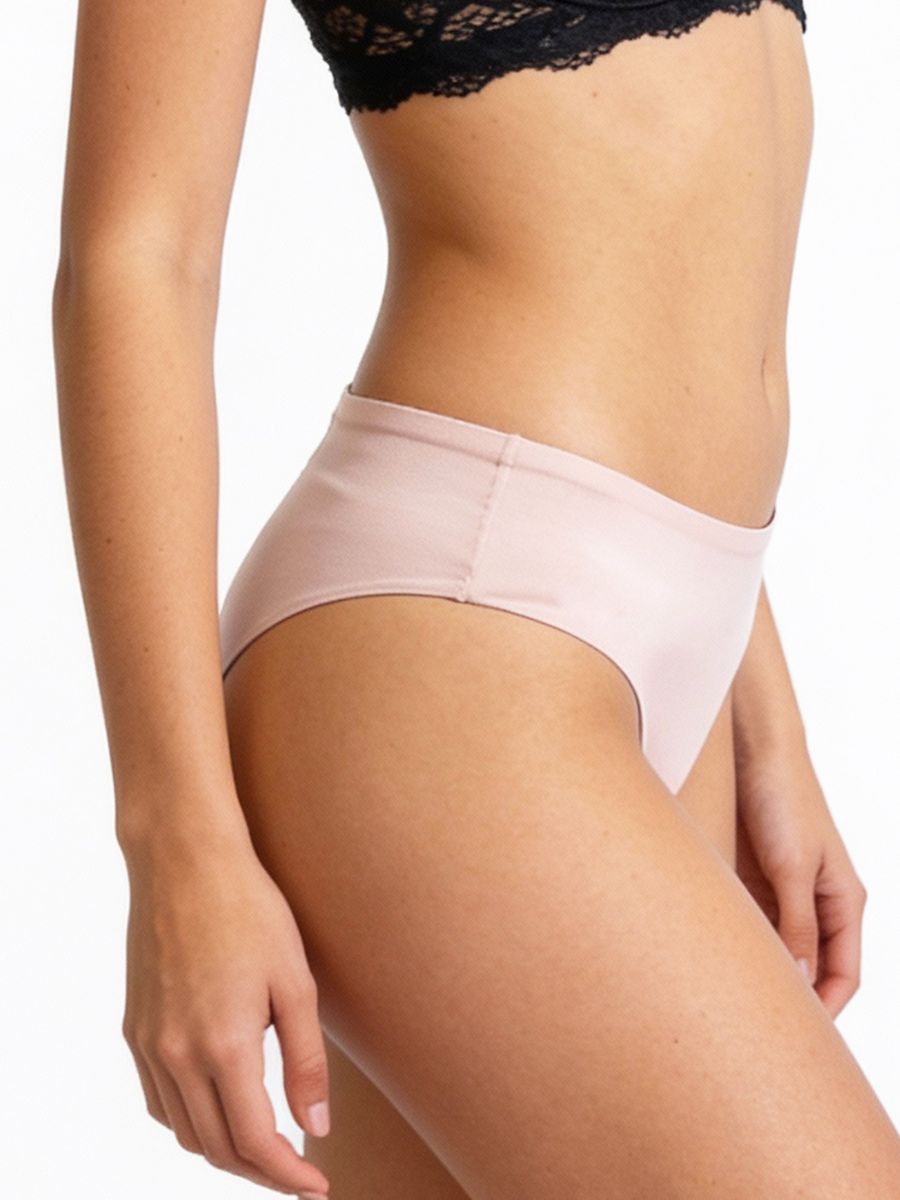 Beige underwear worn by a person on a white background